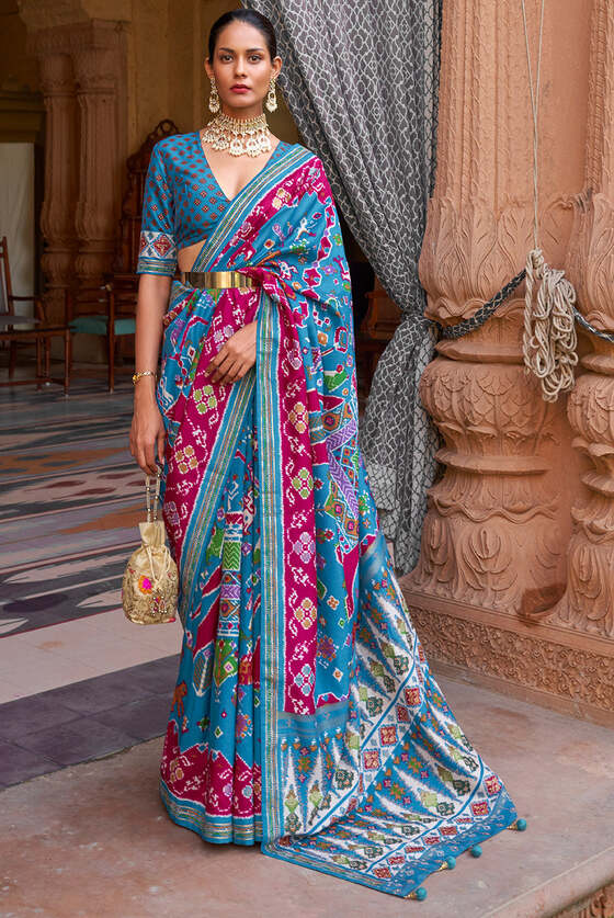 Cerulean Blue Printed Patola Silk Saree With Zari Border & Tassels On Pallu